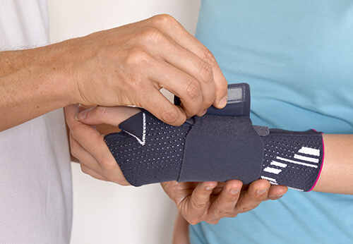 A hand bandage being applied to a wrist