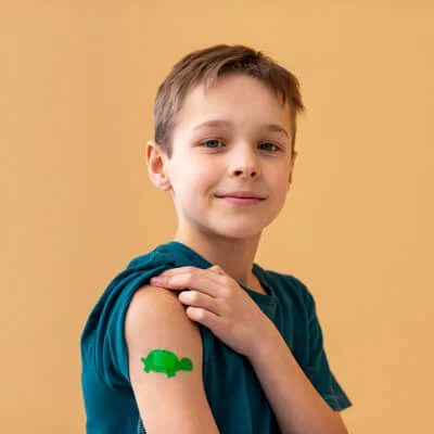 Persistent plaster on the arm of a boy that can be cleaned with wound benzine