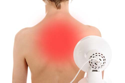 Using a red light lamp for heat therapy on tense body areas