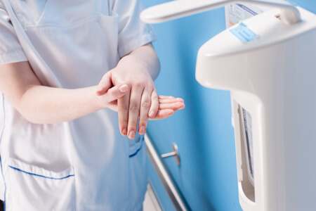 Nurse disinfecting hands