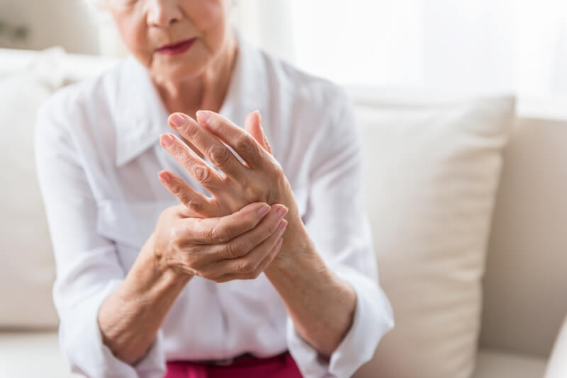 A woman is in pain and needs a hand bandage